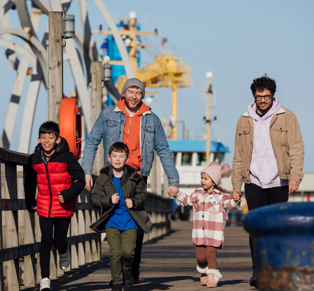Carers walking with children on bridge